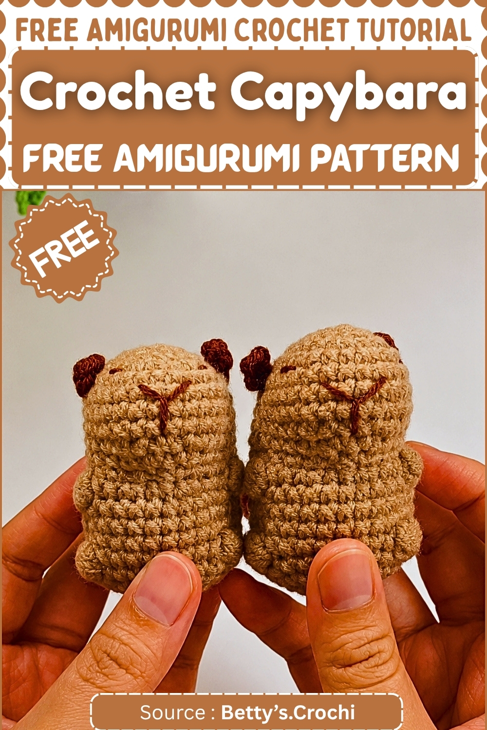 Two completed crochet capybara amigurumi in tan yarn with dark embroidered facial features and small rounded ears held up against a white background.