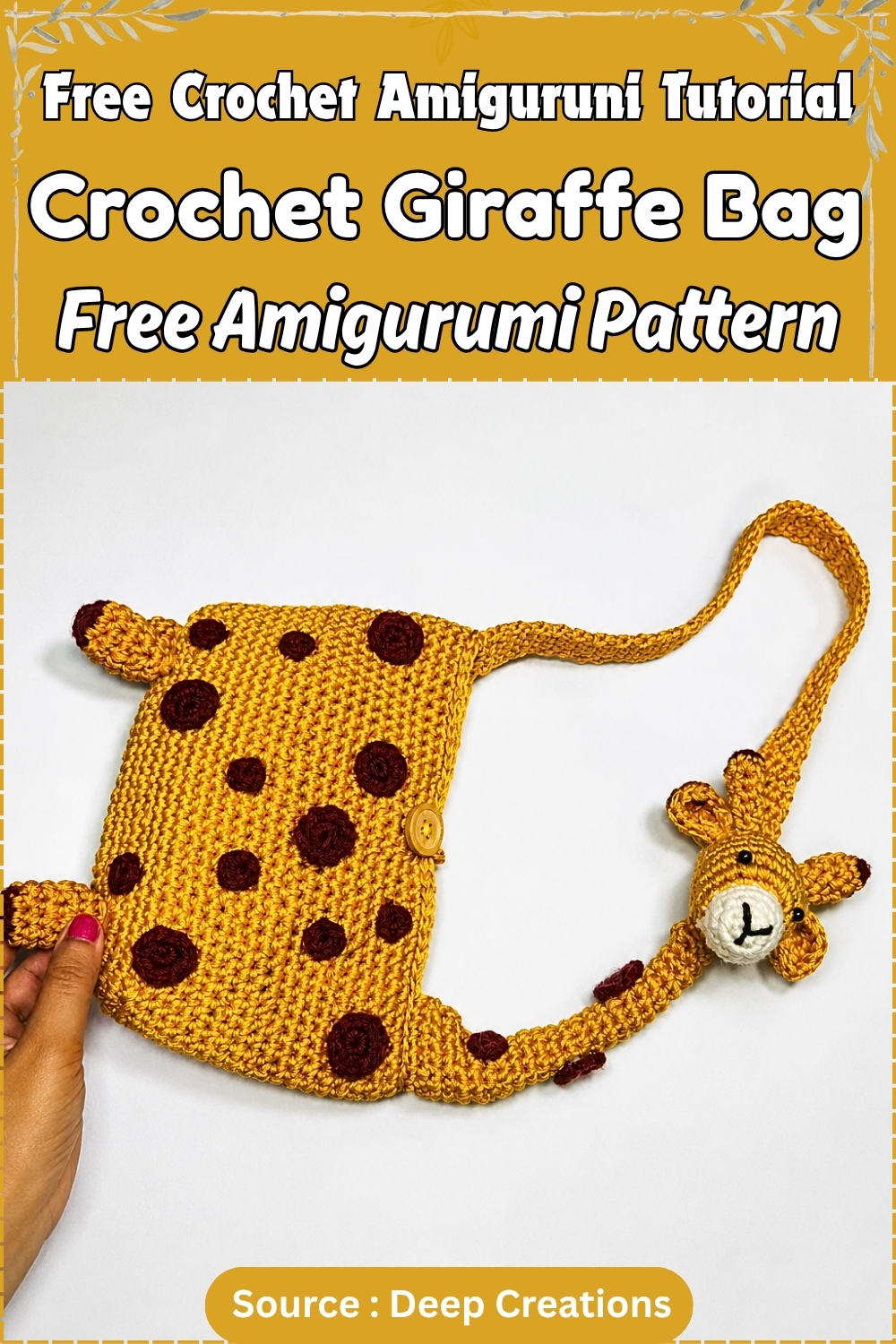 Completed crochet giraffe bag in golden yellow yarn with dark brown spots, corner ear and leg details, a button closure, and a fully formed amigurumi giraffe head at the end of the long crossbody strap, displayed against a white background.