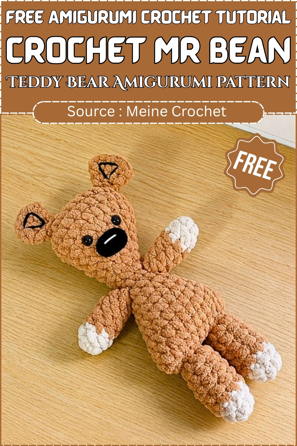 A finished tan chenille crochet Mr Bean teddy bear amigurumi with white paw tips and embroidered ears laid on a wood surface, displayed on a branded free pattern graphic.