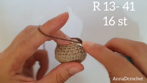 ds crocheting a small beige amigurumi piece with a stitch count overlay showing round 13 at 16 stitches, the piece nearly complete.